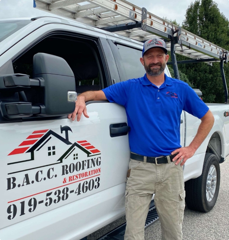 BACC Roofing employe standing infront of BACC Roofing Company Vehicle