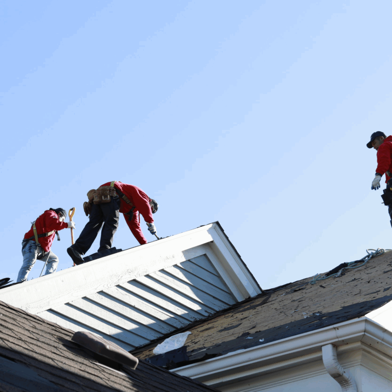 BACC Roofing and Restoration team repairing a house roof