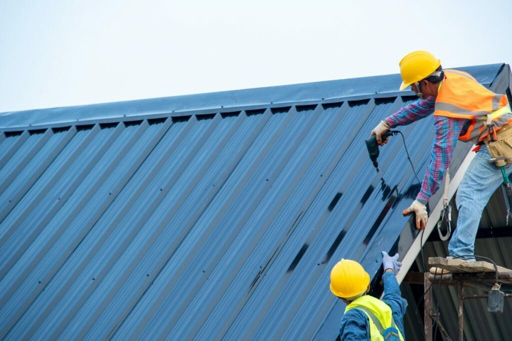 Technician applying metal roof restoration coating
