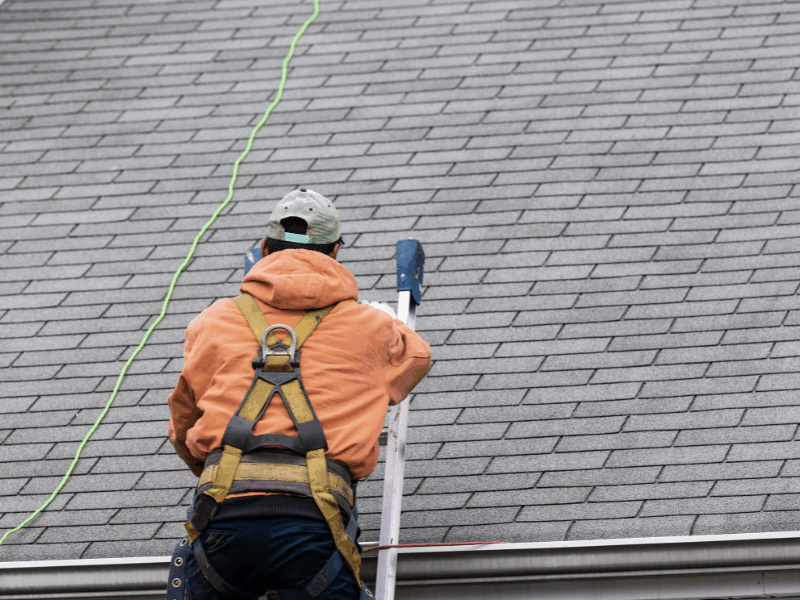 Roofers fixing tiles on a residential roof