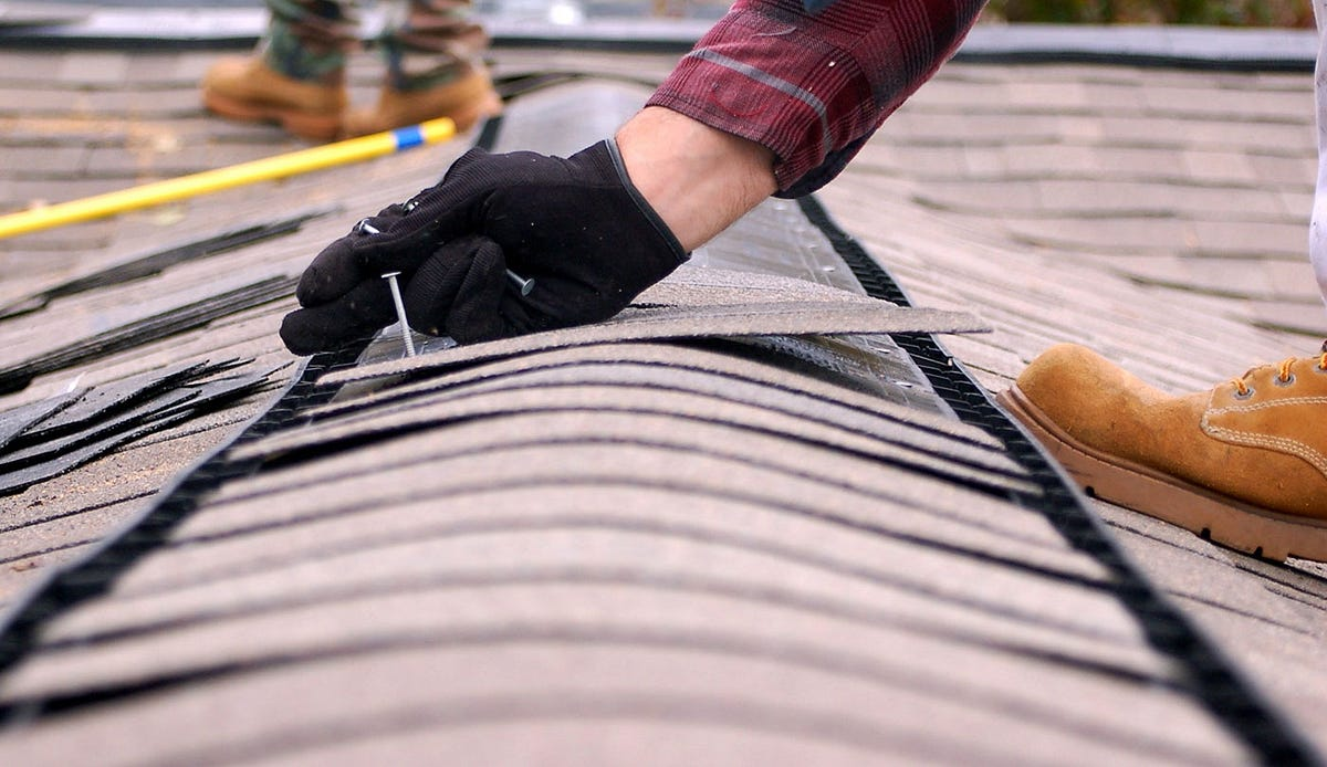 Roofing and restoration specialist repairing storm damage